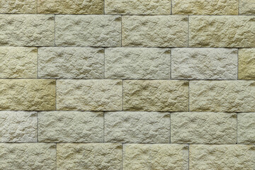 Texture of yellow brick wall as background, closeup