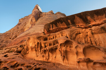 Eroded sandstone walls resembling Swiss cheese at the entrance to Crack Canyon, San Rafael Reef, Utah.