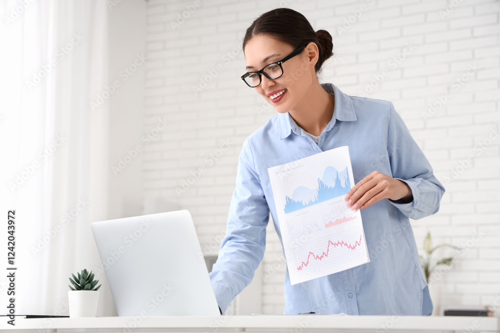 Sticker Young Asian businesswoman with charts and modern laptop giving presentation during online meeting in office