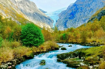 blue clean water is flowing between rock mountains around greenery