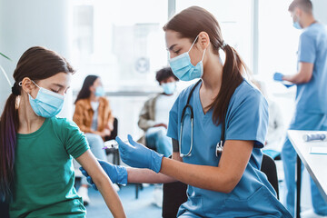 Doctor holding syringe making covid 19 vaccination injection dose in shoulder of little patient. Flu influenza vaccine clinical trials concept, corona virus treatment side effect, inoculation