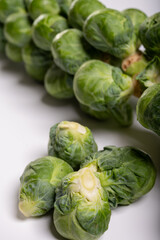 Green brussels sprouts on stalks on white table