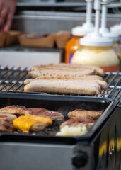 German streetfood, many BBQ wood-fired or charcoal-grilled sausages wurst ready to eat in outdoor cafe, picnic