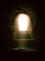 Empty rock tomb and steps leading to an exit flooded with light. Life after death, supernatural and resurrection concept