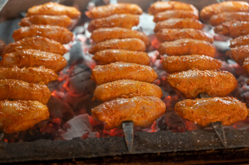 Turkish mixed grill meat, chicken wings, lamb, beef shashlik, kebab cooking on charcoal grill in restaurant