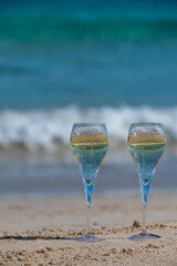 Pouring a glass of champagne on vacation, south of Fuerteventura, Canary islands, blue ocean, mountains