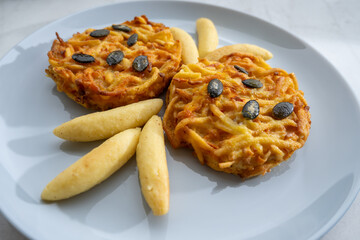 Pumpkin grated roasted patties, rosti or latkes and Fingernudel, finger potato noodle, dumplings...