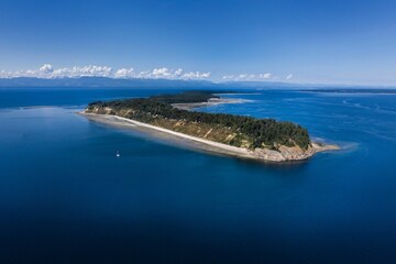 Aerial view of a tranquil island surrounded by blue ocean.