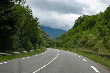 Driving car or camper on free road Route Napoleon in French Alps, touristic road in France