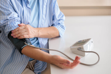 Women's hands measure their own blood pressure with a tonometer. Concept hypotension 