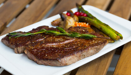 Fried steak entrecote of beef with mushroom and asparagus at plate