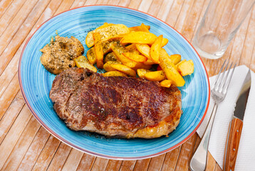 Image of a delicious juicy grilled beef steak and fried potatoes...