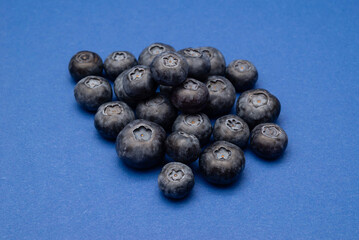Heap fresh blueberries on a blue background