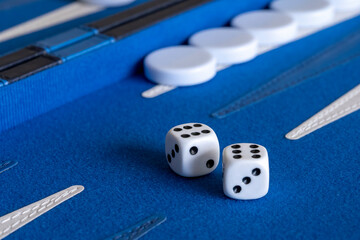 White dices on a blue backgammon board