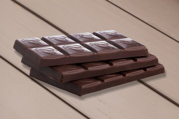 Dark chocolate sweet tasty chunks on desk