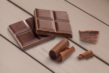 Dark chocolate sweet tasty chunks on desk