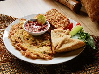 Fried egg tofu and tempeh with chili sauce 