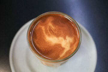 Hot latte coffee on table. Breakfast beverage morning with natural background. Coffee shop at the cafe.