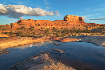 Water filled potholes on slickrock mesa, Needles District, Canyonlands National Park, Utah.