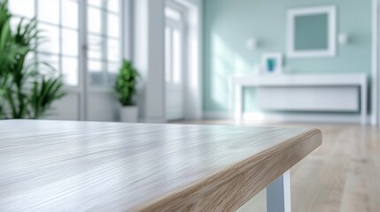 Fototapeta premium A close-up view of a wooden table edge in a stylish interior, featuring large windows, a light-colored floor, and green plants in a serene, modern space.