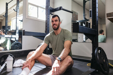 Smiling sweaty athlete portrait in home gym.