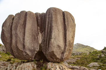 Close-up of large apple-shaped rock on a rocky base.
