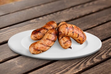 Grilled tasty pork sausages on plate