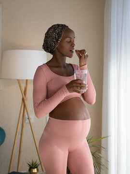 Pregnant woman taking food supplement