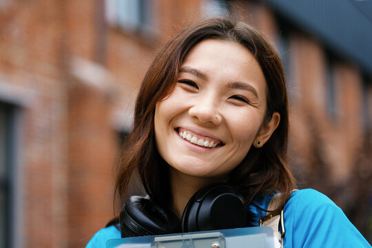 Portrait of young smiling asian female nurse looking at camera