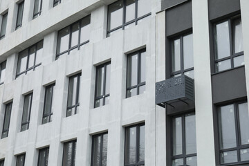 Modern building with many windows outdoors, low angle view
