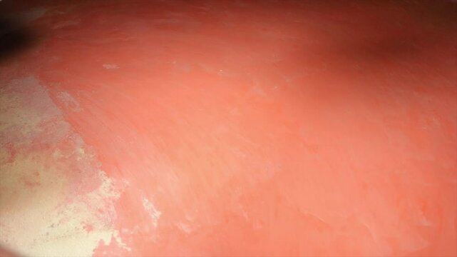 Person's back is covered in red paint