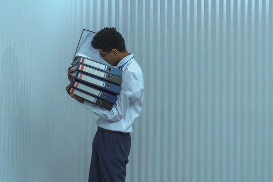 Man Holding Stack of File Binders
