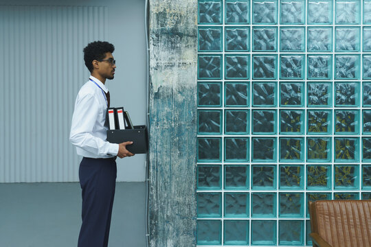 Man Holding File Box in Office Setting