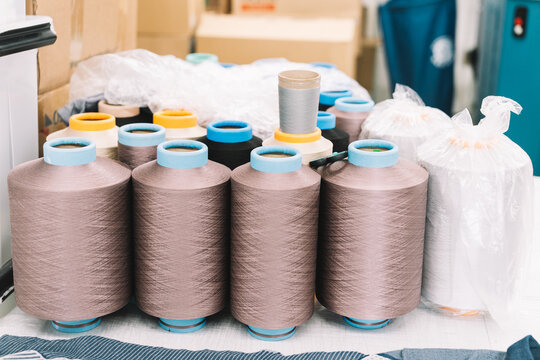 Spools of thread organized on a workspace in a textile factory