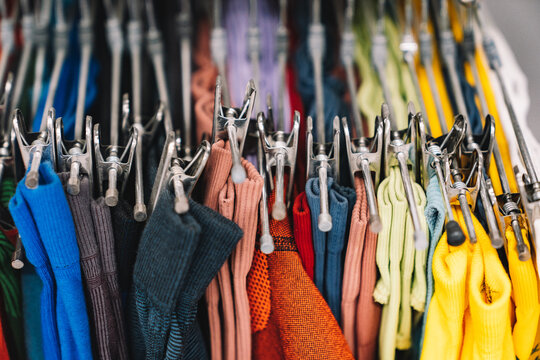 Colorful assortment of hanging clothes in a retail store display