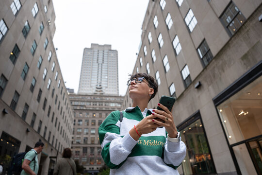 Tourist using smartphone and exploring manhattan, new york city