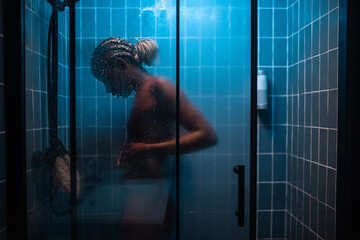 Woman washing in hot shower