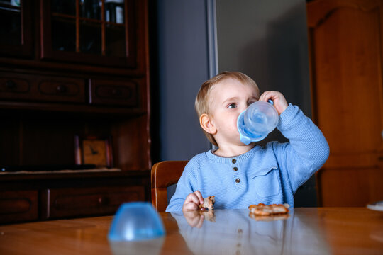 Baby boy drinking from the sippy cup