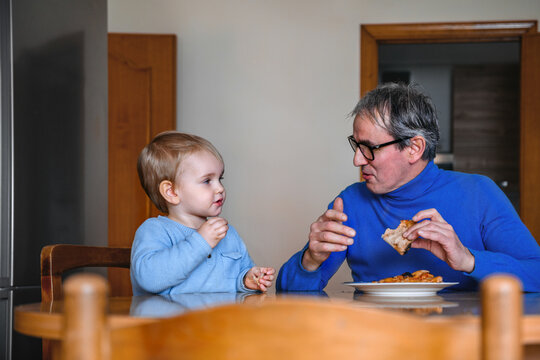 Father and son eating pizza