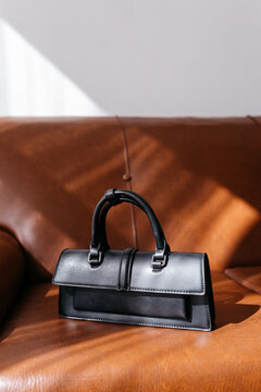 Black leather bag placed on sofa