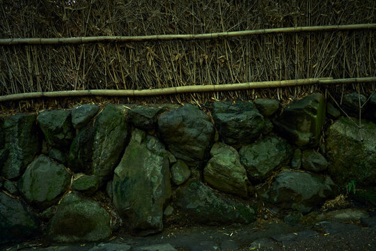 A rock and bamboo fence.
