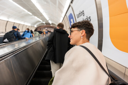 Young woman going up escalator in New York City subway station