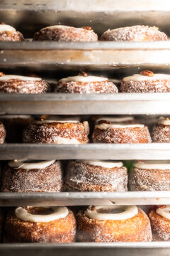 Cooling racks storing cronuts with sugar and glaze topping