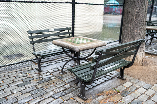 Checkerboard table and benches inviting to play in New York City park