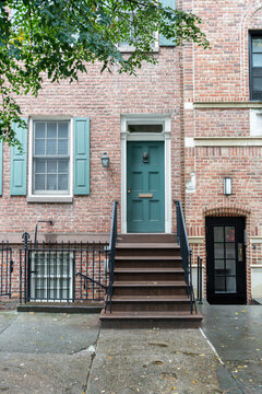 Elegant teal front door of a brownstone building in New York City