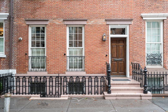 Elegant brownstone facade with wrought iron fence in New York City