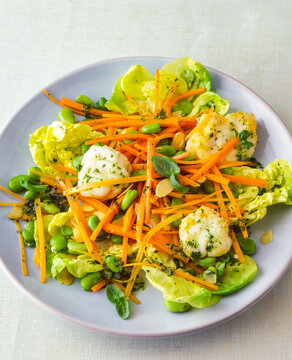 salad with fish fillet, carrots, and green beans served on a plate