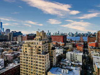 Fototapeta premium Cityscape view of buildings and skyline under a partly cloudy sky.