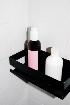 A compact bathroom shelf holding a selection of cosmetics