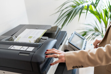 Office worker using a modern multifunction printer